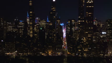 Aerial-tracking-shot-in-front-of-skyscrapers-of-Billionaires'-Row,-night-in-New-York,-USA