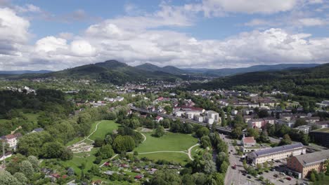 Baden-Baden,-Germany:-Aerial-view-of-town,-mountains,-and-highway