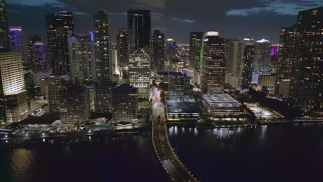 Aerial-drone-view-of-Miami-Macarthur-Causeway-Bridge-to-the-beach-at-night,-Florida,-USA