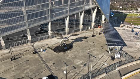 Aerial-descending-shot-of-silver-steel-falcon-statue-in-front-of-Mercedes-Benz-Stadium-in-Atlanta