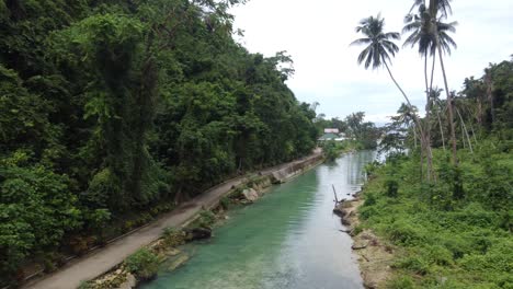 Blue-clear-water-of-Matutinao-creek-in-lush-tropical-jungle-in-Badian,-Cebu
