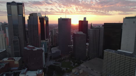 Drone-shot-flying-in-middle-of-skyscrapers-in-downtown-Dallas,-sundown-in-TX,-USA