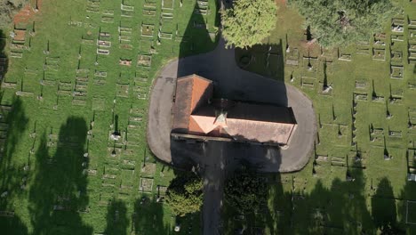 Top-View-Of-Chapel-Over-Sunny-Graveyards-Of-Wymondham-Cemetery,-Wymondham,-Norfolk,-England,-UK