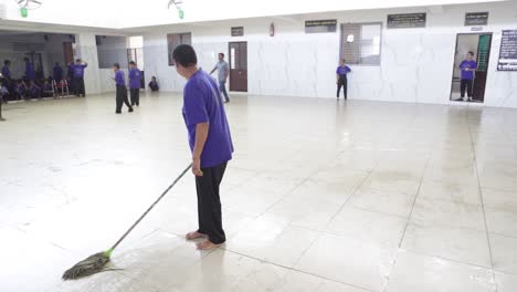 A-mentally-retarded-woman-cleans-the-NGO-campus-and-defecates-on-the-tiles