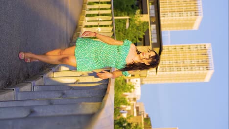 naturally-beautiful-glamorous-model-of-mixed-ethnicity-Romani-European-Gypsy-standing-by-the-fence-leaning-with-one-hand-during-sunset-then-walking-towards-the-camera-mysterious-lady-slowmo-vertical