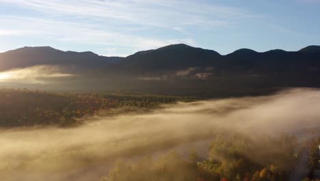 Foggy-valley-floor-with-mountains-and-blue-sky-morning-light