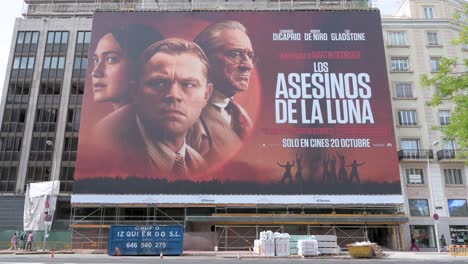 A-large-advertisement-billboard-promoting-the-movie-Killers-of-the-Flower-Moon,-produced-by-Paramount-Pictures-and-Apple-Studios,-and-directed-by-Martin-Scorsese-seen-in-the-street-of-Madrid,-Spain