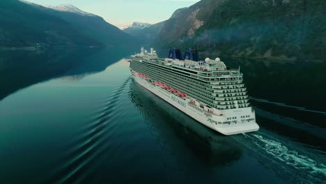 Following-a-Ship-in-Nordic-Fjord,-Dramatic-Overcast,-Dark-Water