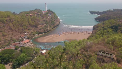 Baron-beach-full-of-tourist-in-Indonesia,-aerial-view
