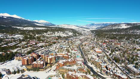 Breckenridge-Colorado-Rocky-Mountain-Town-with-Vacation-Homes,-Resorts-and-Hotels-for-Travel-in-Snow-Covered-Winter-Ski-Weather,-Aerial-Drone-View