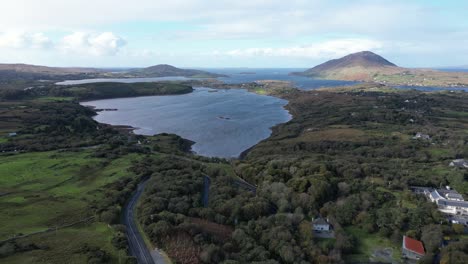 Aerial-panorama-view-over-Connemara-National-Park,-Galway-County,-Ireland,-with-scenic-waters-and-stunning-mountains-against-a-blue-sky