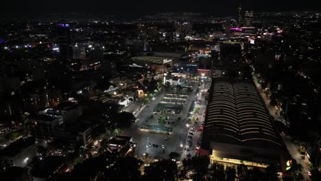 Nighttime-flyover-of-a-shopping-mall-parking-lot-in-the-Del-Valle-neighborhood-in-Mexico-City