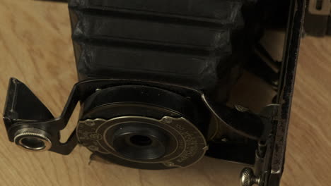 Closeup-lens,-bellows-of-vintage-Kodak-camera-revolves-through-frame