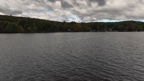 A-low-altitude-view-over-Oscawana-Lake-in-NY-during-the-fall-on-a-cloudy-day