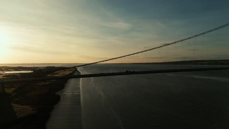 A-symphony-of-light-and-movement:-Humber-Bridge-at-sunset-with-cars-in-graceful-procession