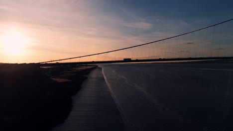 The-art-of-movement:-Aerial-view-of-Humber-Bridge-at-sunset-with-cars