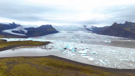 Aerial-shot-of-the-impact-of-global-warming-has-melting-the-Fjallsárlón-Glacier,-Iceland