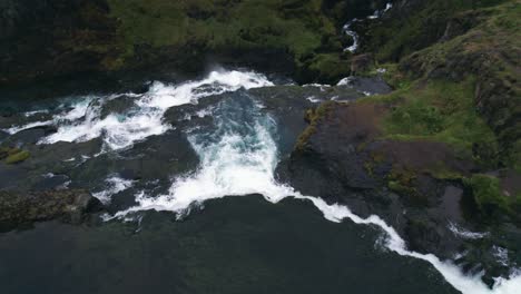 Aerial:-flyover-and-down-Reykjafoss-waterfall-and-its-powerful-cascade-of-water