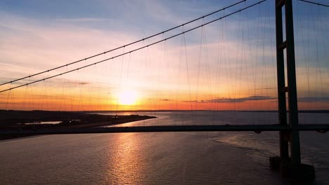 Aerial-drone-shot:-Humber-Bridge-at-sunset-with-cars-in-serene-motion