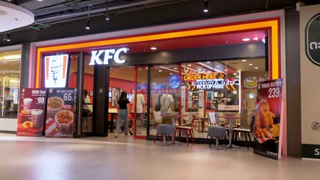 KFC-Kentucky-fried-chicken-fast-food-restaurant-entrance-in-MBK-center-Bangkok-shopping-mall,-Thailand