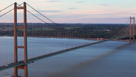Sunset's-embrace:-Aerial-view-of-Humber-Bridge,-cars-crossing-gently