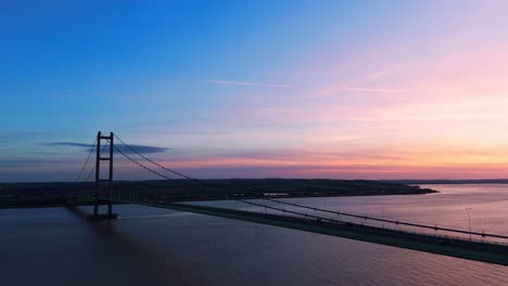 Sunset's-charm:-Aerial-view-of-Humber-Bridge-with-cars-in-graceful,-synchronized-motion