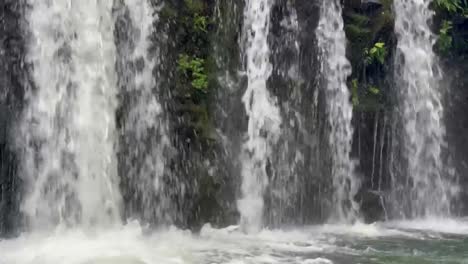 Cinematic-close-up-booming-down-shot-of-Upper-Waikani-Falls-along-the-Road-to-Hana-in-Maui,-Hawai'i