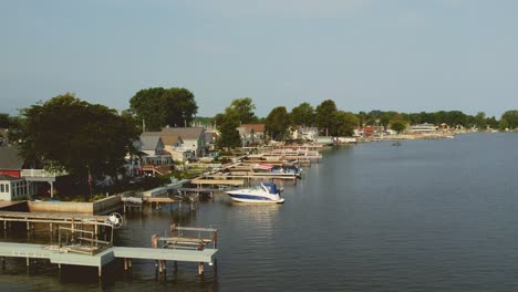 Drone-shot-of-the-beach-houses-at-and-docks-and-boats-and-waterSodus-point-New-York-vacation-spot-at-the-tip-of-land-on-the-banks-of-Lake-Ontario