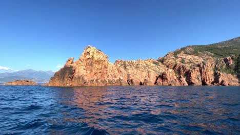 Calanques-de-Piana-landscape-and-seascape-in-Corsica-island-as-seen-from-moving-boat-in-summer-season,-France