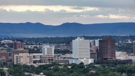 A-serene-view-of-Albuquerque's-skyline-during-sunrise,-with-the-mountains-casting-a-tranquil-backdrop-and-city-buildings-standing-tall-in-the-foreground
