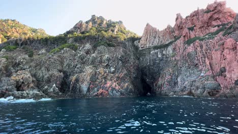 Amazing-Calanques-de-Piana-volcanic-rock-formations-in-Corsica-island-as-seen-from-moving-boat-in-summer-season,-France