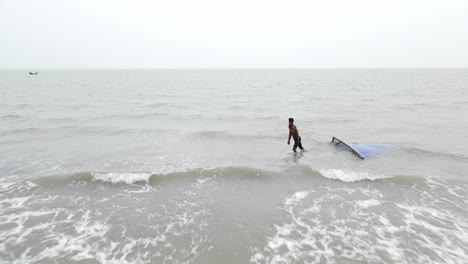 Fisherman-Pulling-A-Fishing-Net-Over-Seascape-Of-The-Bay-of-Bengal,-At-Kuakata-Beach-In-Patuakhali,-Bangladesh