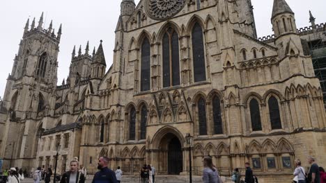 Static-shot-of-tourists-walking-in-front-of-the-beautiful-historic-York-Minster