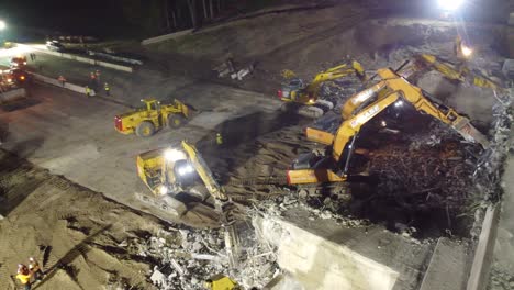 Drone-view-of-the-destruction-of-a-building-by-excavator-in-close-up