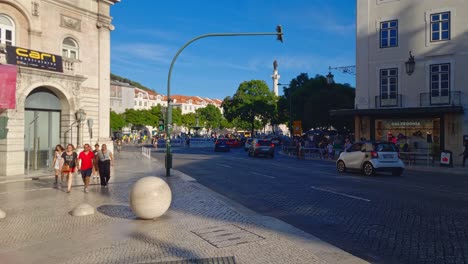 Busy-city-centre-in-Lisbon-and-people-go-about-their-business-and-tourists-sightsee