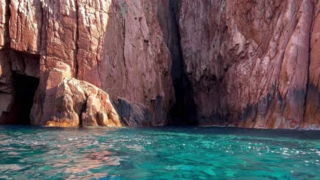 Magnificent-Scandola-peninsula-nature-reserve-in-summer-season-as-seen-from-moving-boat,-Corsica-island-in-France