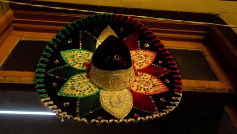 Slow-orbiting-shot-of-a-Mexican-sombrero-hanging-on-a-wall