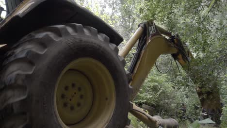 A-backhoe-loader-digging-through-the-vegetation-with-its-bucket