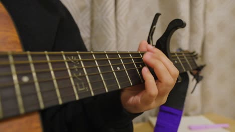 Close-up-of-caucasian-person-playing-chords-on-acoustic-guitar