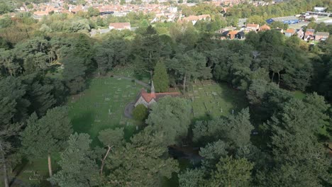 Panoramic-Aerial-View-Of-Wymondham-Cemetery-Surrounded-By-Trees-In-Wymondham,-Norfolk,-England,-UK