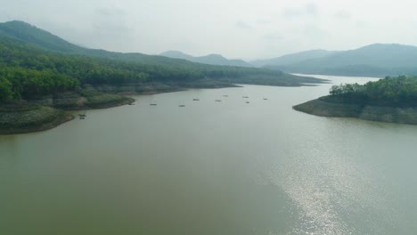 4K-Luftaufnahme-Eines-Ruhigen-Flusses,-Umgeben-Von-Bergen-Und-Klarem-Himmel-In-Thailand