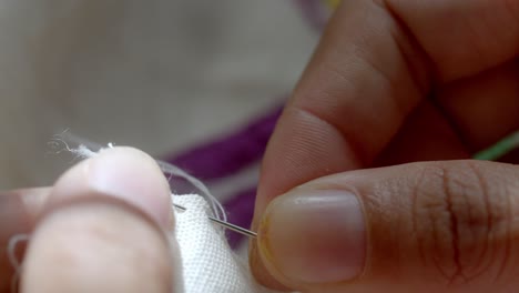 Using-needle-and-thread-to-sew-material