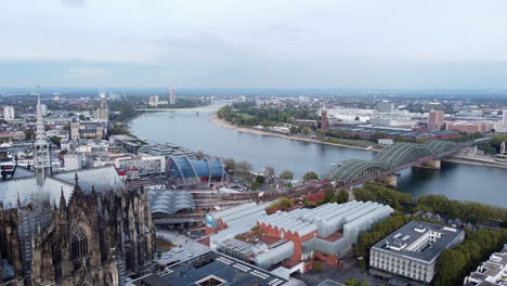 Drone-flight-from-Rhine-river-and-Hohenzollern-Bridge-past-Cologne-Cathedral
