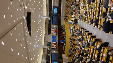 Vertical-portrait-of-the-European-Parliament-congress-plenary-hall-crowded-with-deputies---Brussels,-Belgium