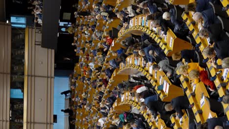 Vertical-video-of-the-European-Parliament-congress-plenary-hall-with-politicians-applauding-after-speech-in-Brussels,-Belgium---panning-shot