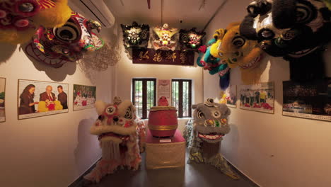 Exhibition-hall-with-numerous-Chinese-lion-heads-and-memorable-photos-at-Traditional-lion-dance-centre-in-Guangzhou,-China