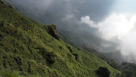 Ein-Schwenkblick-Auf-Die-Steile-Alm-Im-Himalaya-Gebirge,-Während-Der-Frühmorgendliche-Nebel-Und-Die-Wolken-Im-Morgenlicht-über-Die-Landschaft-Fegen