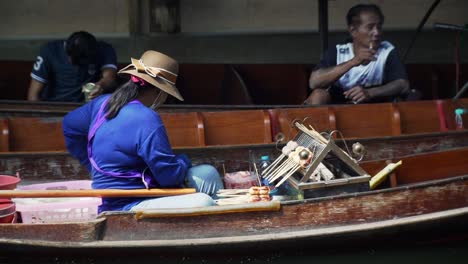 Woman-Cooking-Food-at-Floating-Market-in-Asia