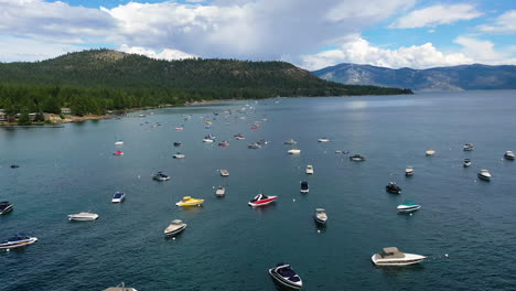 Aerial-view-over-boats-on-the-coastline-of-Lake-Tahoe,-in-partly-sunny-CA,-USA