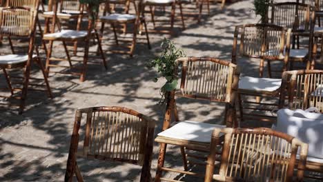 Bamboo-chairs-with-white-cushions-arranged-for-outdoor-event